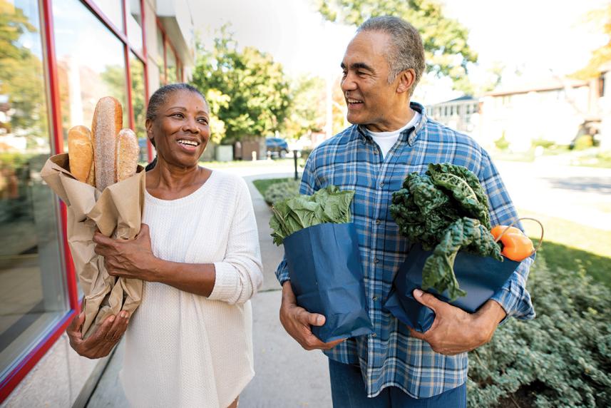 Couple holding groceries