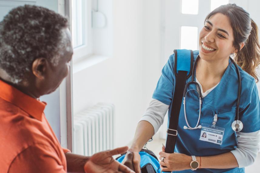 A man shaking hands with a nurse