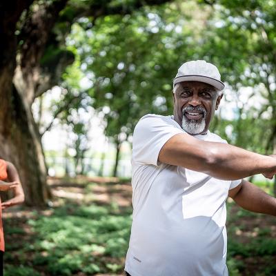 An older couple stretching outside