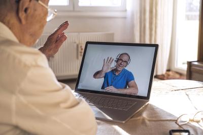 An older man on a video call with a medical advisor