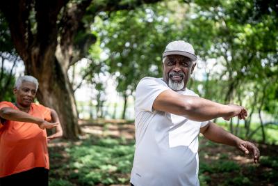 An older couple stretching outside