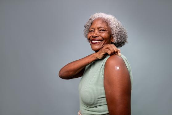 A woman with a bandage on her arm