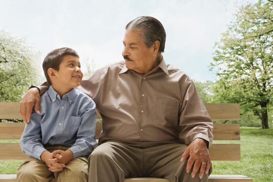 man and boy sitting on a bench
